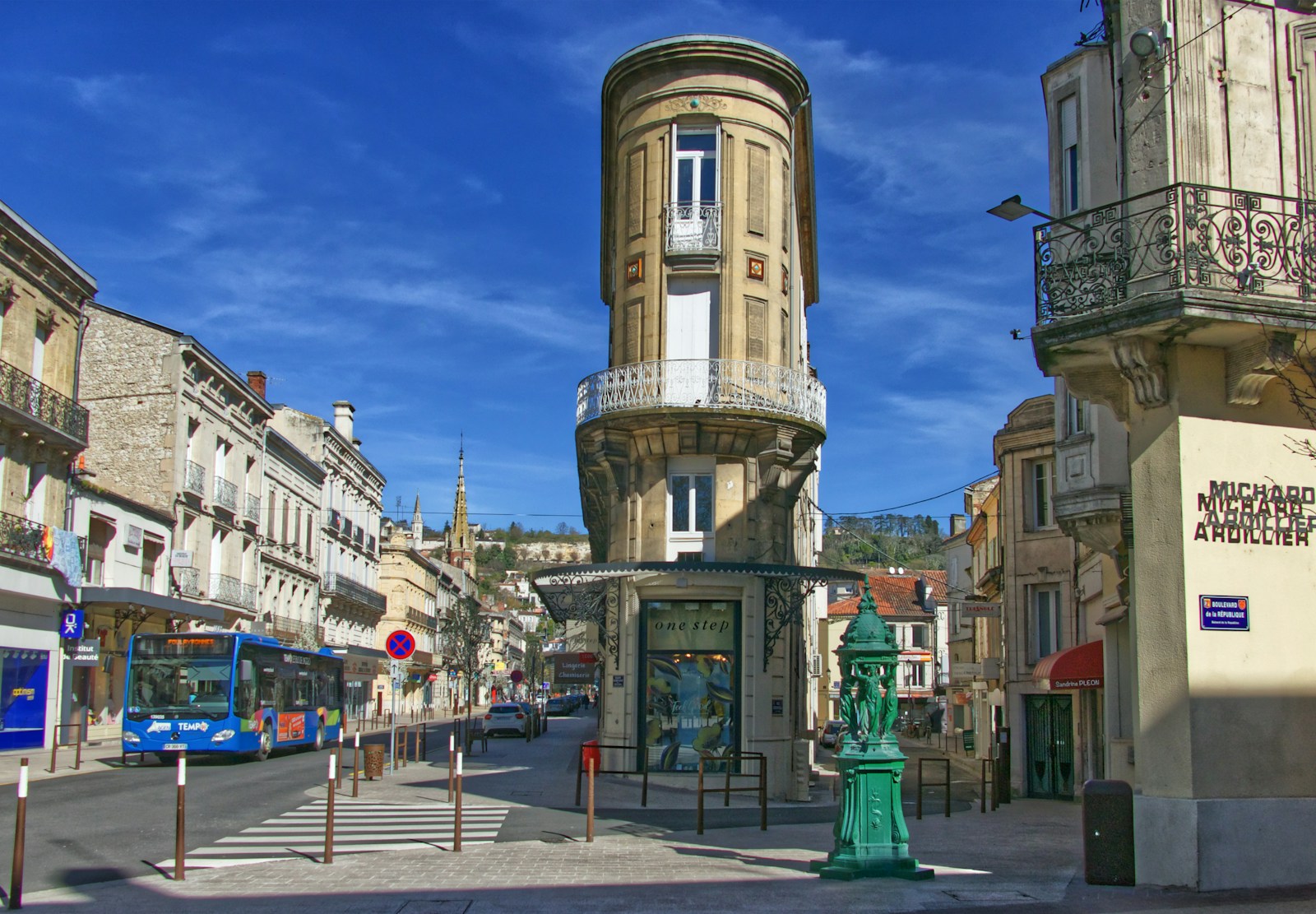 blue bus parked beside building during daytime