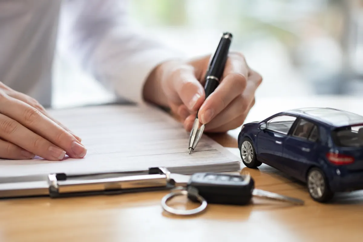 Le vrai délai de rétractation pour une assurance auto expliqué Gros plan sur les clés d'une voiture posées sur un contrat d'assurance signé